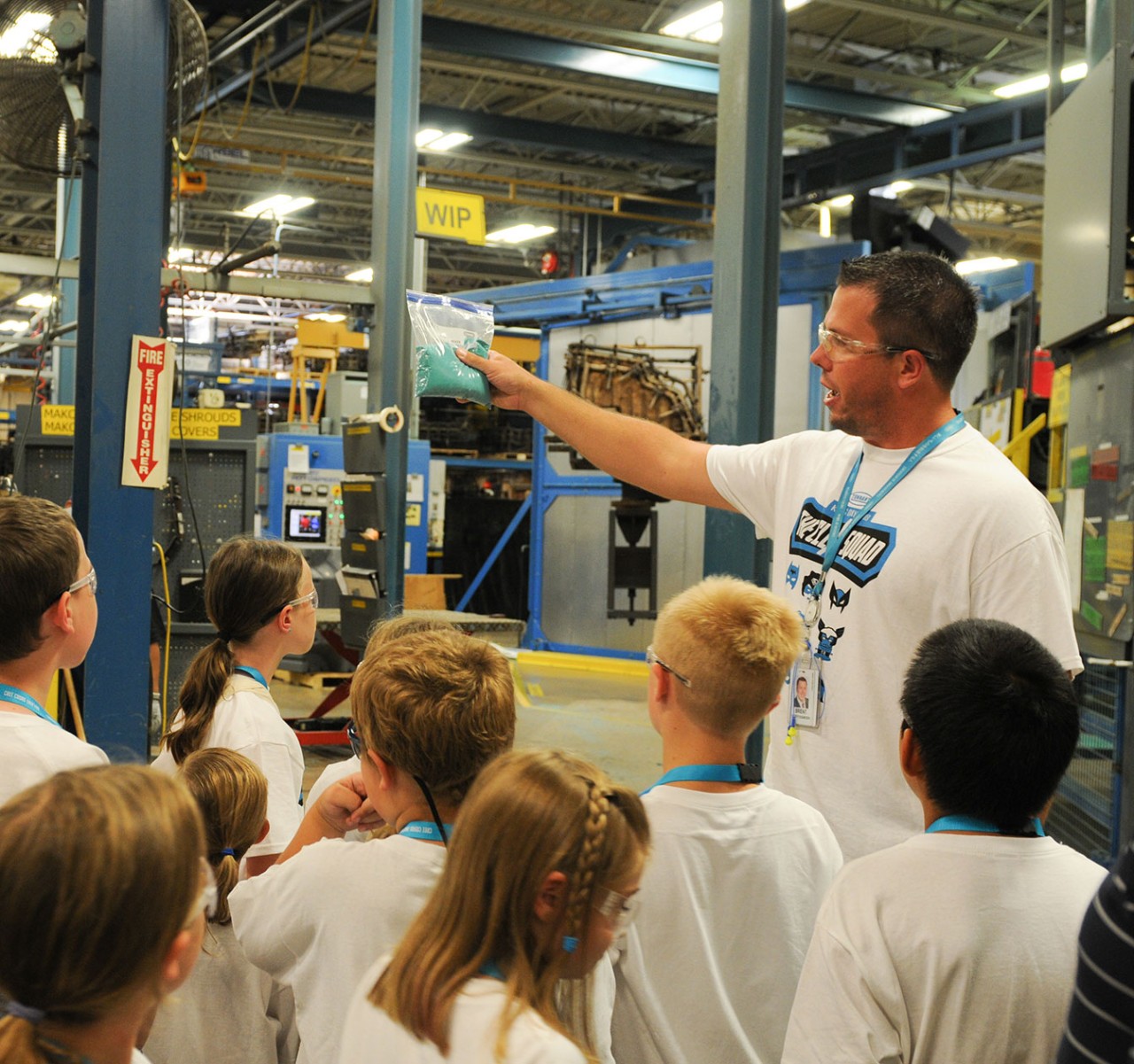 A Tennant employee giving a tour of the manufacturing plant.