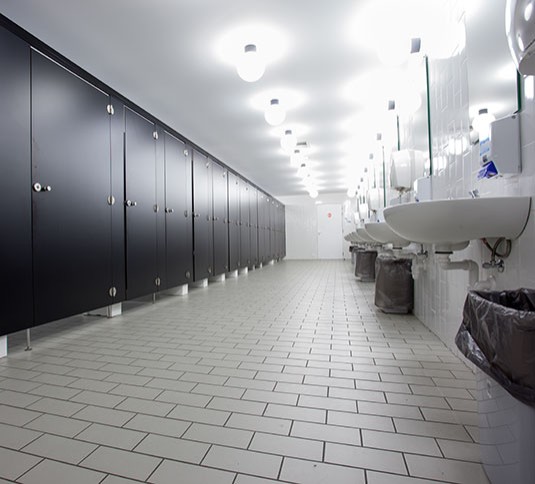 Restroom facility with multiple surfaces to clean
