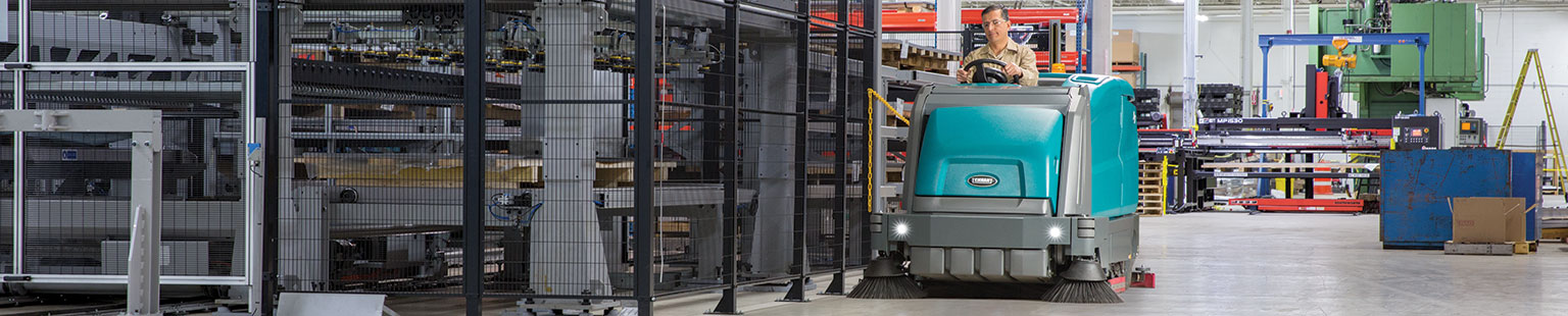 M17 Ride-On Sweeper-Scrubber cleaning a manufacturing facility