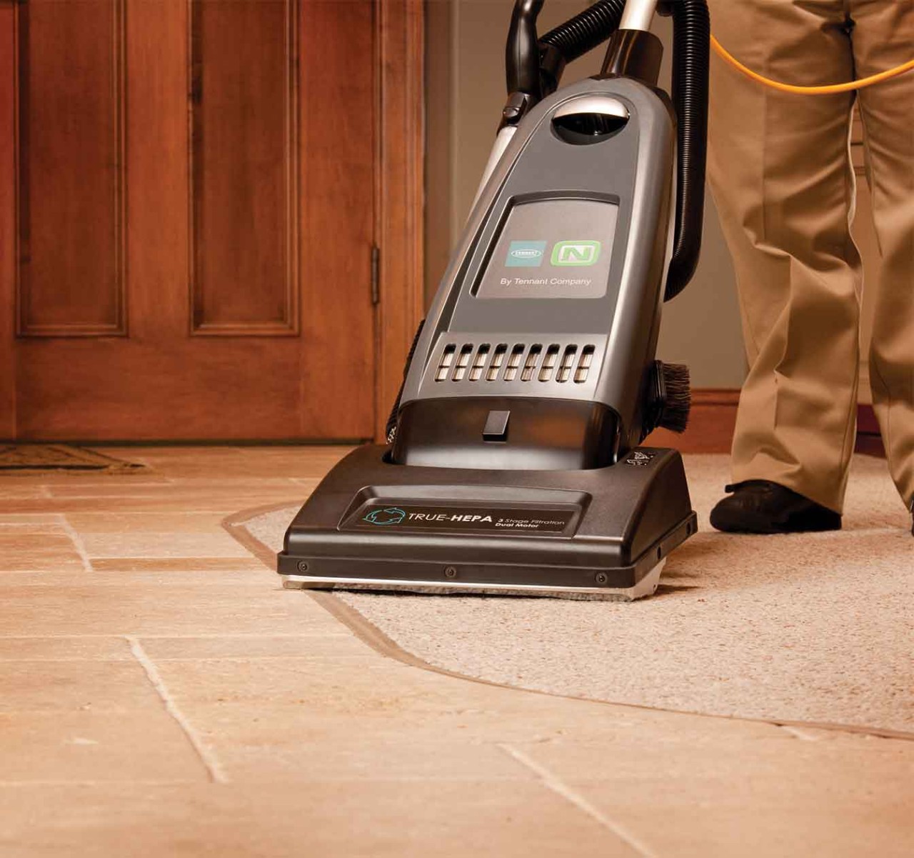 The V-DMU-14 Dual Motor Upright Vacuum cleaning two different surfaces.