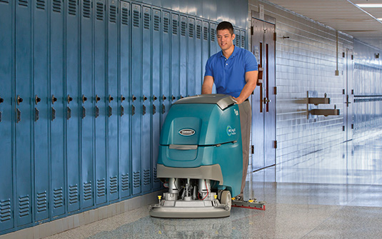 cleaner cleaning school hallways during the summer