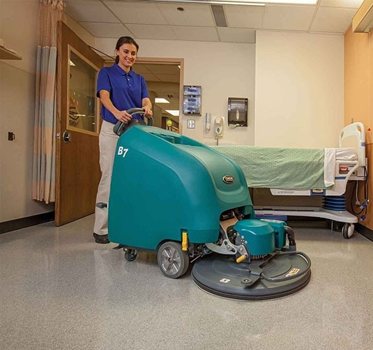 Custodian using the B7 Battery Burnisher in a hospital room.
