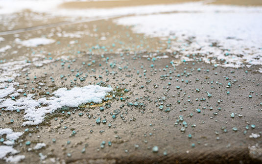 blue salt rock on black asphalt walkway
