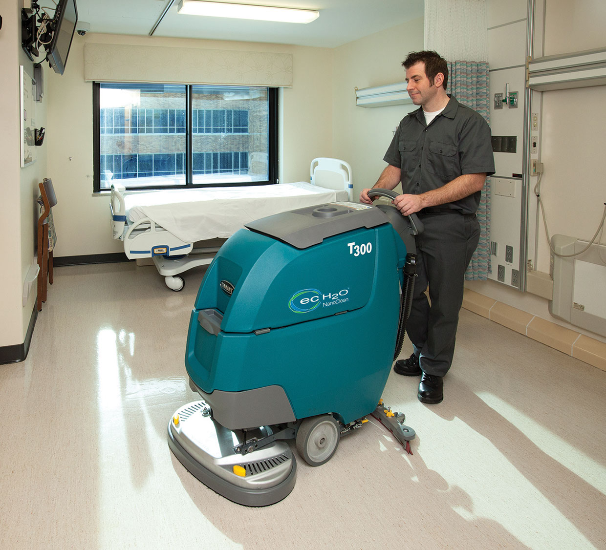 Cleaning a patient room with a scrubber