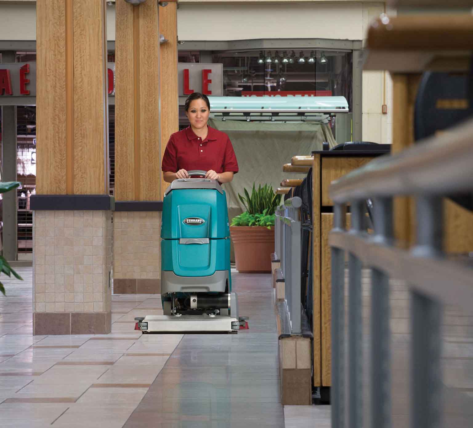 cleaning using tennant walk behind floor scrubber to clean mall