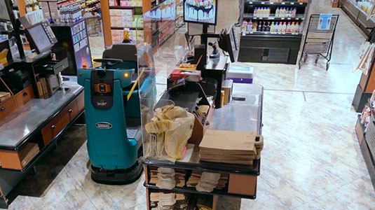 tennant automated robotic floor scrubber cleaning grocery store