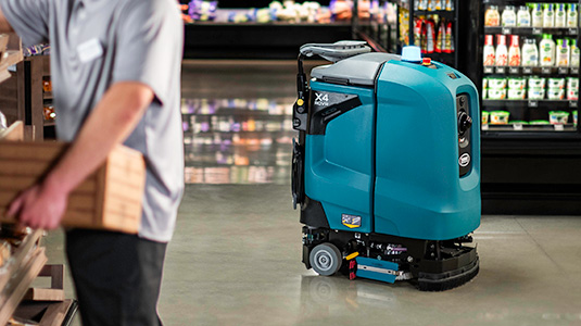 X4 ROVR Autonomous Floor Scrubber in a grocery store / supermarket